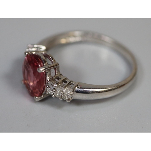 256 - 9ct white gold ring set with an oval pink stone and diamonds.  Ring size O.  Approx weight 2.8 grams... 