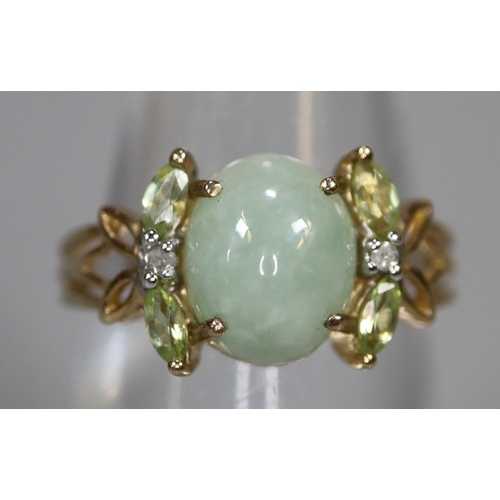 259 - 9ct gold ring set with green hardstone dress ring with foliate shoulders set with diamond chips.  Ri... 