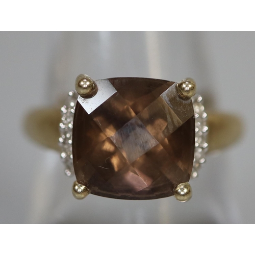 264 - 9ct gold dress ring set with a brown stone and diamonds.  Ring size P.  Approx weight 3.1 grams.
(B.... 