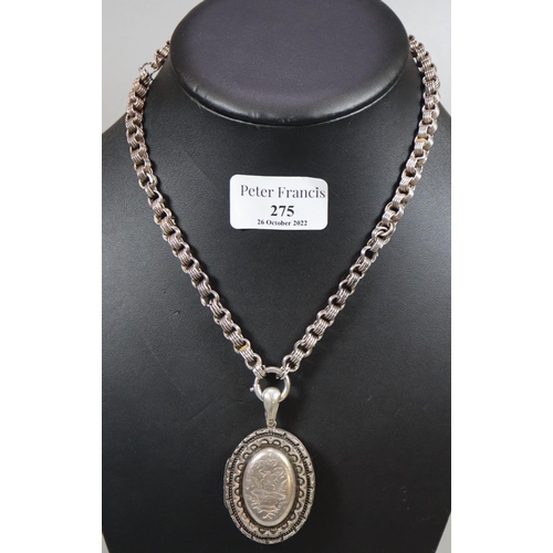 275 - Victorian white metal oval shaped engraved locket and chain.  (B.P. 21% + VAT)