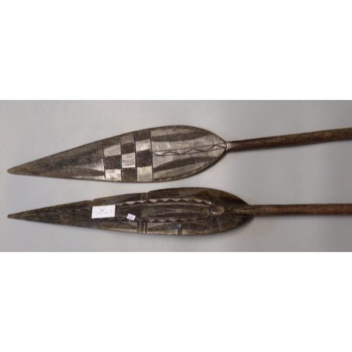 484 - Two similar hardwood tribal chip carved paddles.  (2)  (B.P. 21% + VAT)