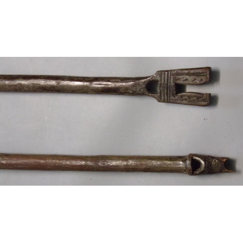 484 - Two similar hardwood tribal chip carved paddles.  (2)  (B.P. 21% + VAT)