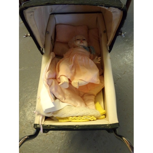 491 - Vintage dolls pram, appearing unmarked, with mid century plastic doll.  (B.P. 21% + VAT)