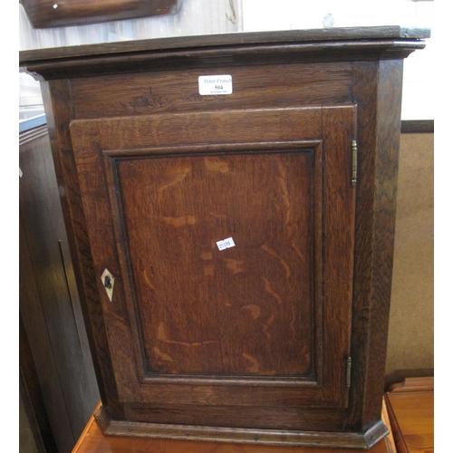 504 - 19th century oak single door blind panelled hanging corner cupboard, the interior revealing shaped s... 