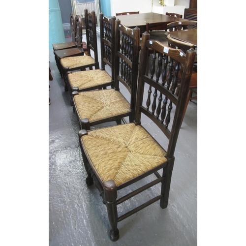 519 - Set of four Lancashire style oak spindle back dining chairs with rush seats on turned supports and l... 