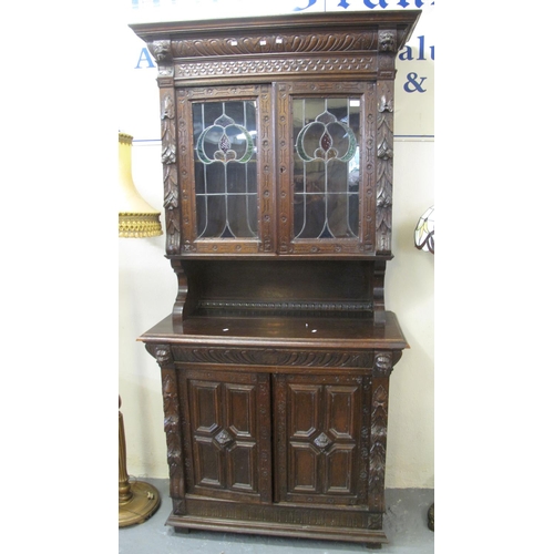 542 - Late 19th century oak Flemish design ornately carved two stage stained and leaded glass cabinet back... 