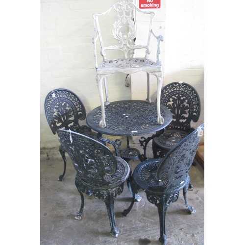 558 - Modern weathered metal pierced garden table with four matching chairs, together with another weather... 