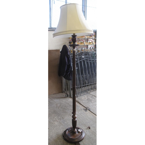 569 - Modern mahogany standard lamp on a circular moulded base with shade.  (B.P. 21% + VAT)