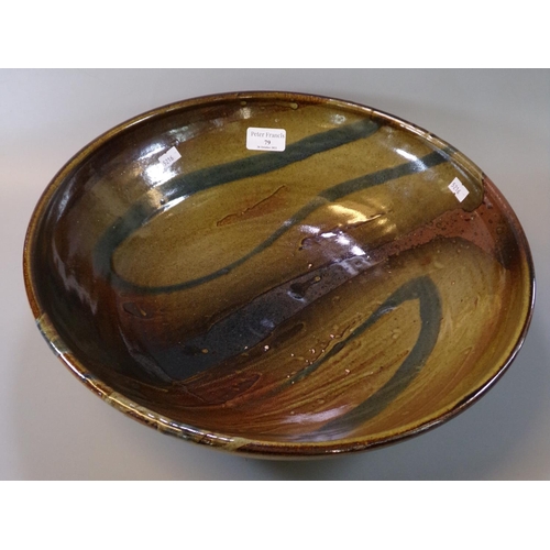 79 - Large art pottery circular bowl, brown glazed with swirl decoration. Indistinct impressed mark to th... 