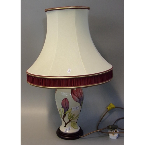 92 - Moorcroft art pottery tube lined table lamp with shade, in the 'Magnolia' pattern.
(B.P. 21% + VAT)