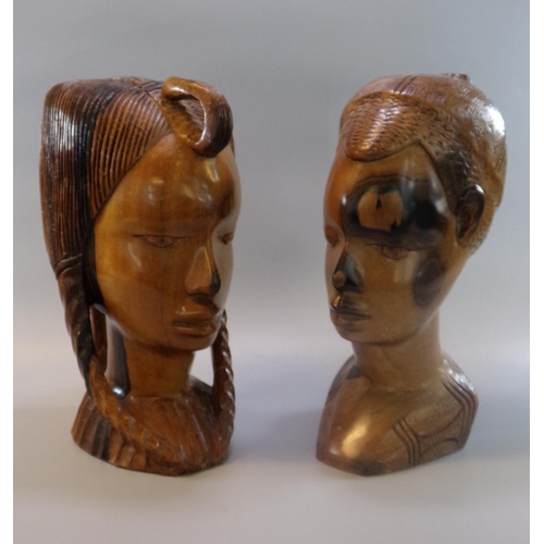 120 - Carved hardwood African bust of a male together with another of a female with plaits in her hair.  (... 