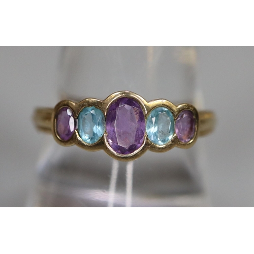 243 - 9ct gold five stone dress ring, set with amethyst and aquamarine stones.  Ring size Q.  (B.P. 21% + ... 