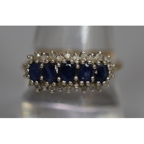 264 - 9ct gold dress ring set with five sapphires and diamond chips.  2.5g approx.  Ring size R.  (B.P. 21... 