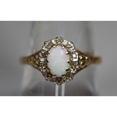 268 - 9ct gold dress ring set with single opal and diamond chips.  2.6g approx.  Ring size O.  (B.P. 21% +... 