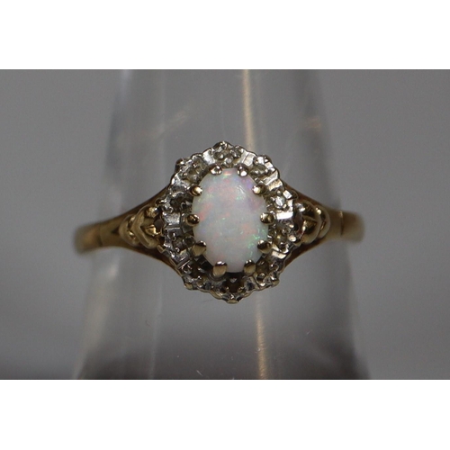 268 - 9ct gold dress ring set with single opal and diamond chips.  2.6g approx.  Ring size O.  (B.P. 21% +... 