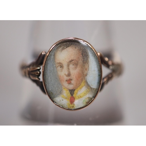 271 - 19th century Georgian style gold signet ring set with miniature portrait panel of a young gentleman.... 