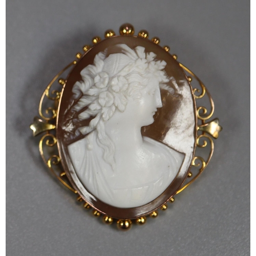 275 - 9ct gold scroll work framed carved cameo brooch.  (B.P. 21% + VAT)