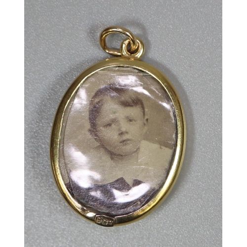 281 - 9ct gold locket  set with enamel and seed pearl, containing photograph of a young boy.  3.9g approx.... 