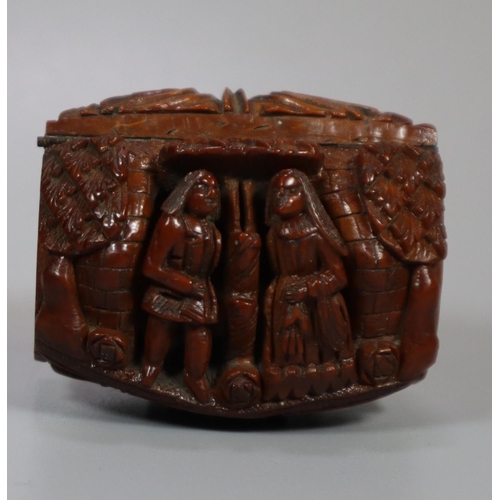 312 - Unusual carved Coquilla nut snuff box decorated with figures and bust to the reverse, appearing to b... 