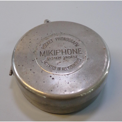 44 - A 'Mikiphone' aluminium ,steel and Bakelite pocket phonograph, 'System VADASZ', 11cm dimeter approx....