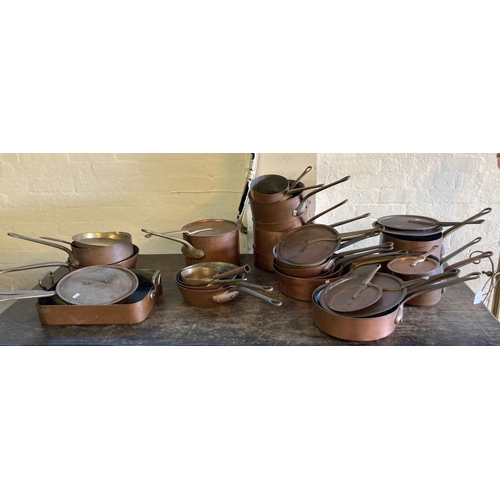 486 - Large collection of 19th century copper kitchen pans and saucepans, some with lids and having iron o...