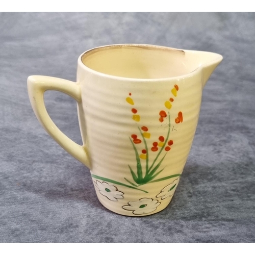 182 - Clarice Cliff  Lynton milk jug in the dry days pattern. 7cm high approx. 
(B.P. 21% + VAT)