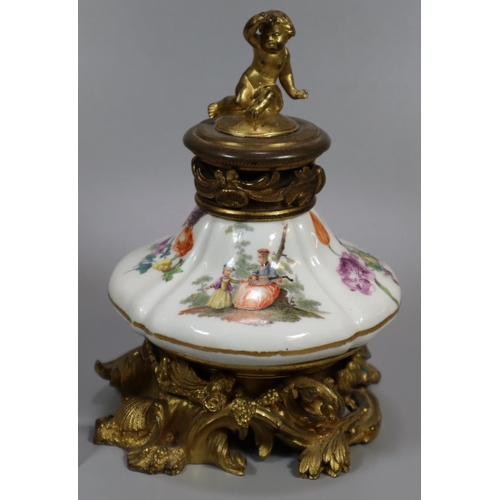 195 - Continental porcelain and ormolu single desk inkwell, the lid with cherub finial above a porcelain b... 