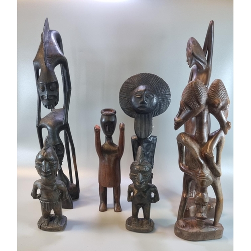 230 - A group of carved wooden ethnic figures, African, Balinese etc.  21cm high up to 52cm high approx.  ... 