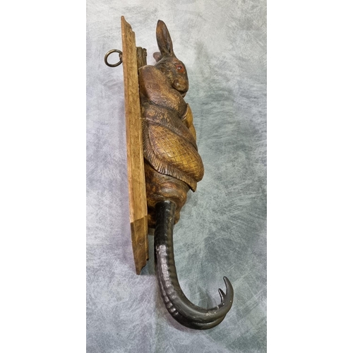 232 - Carved Black Forest style hare coat or game hook, with glass eyes dressed as a huntsman with rifle o... 