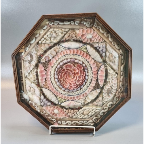 238 - 19th century sailor's valentine seashell mosaic in octagonal framed case with glass front.  35x34cm ...
