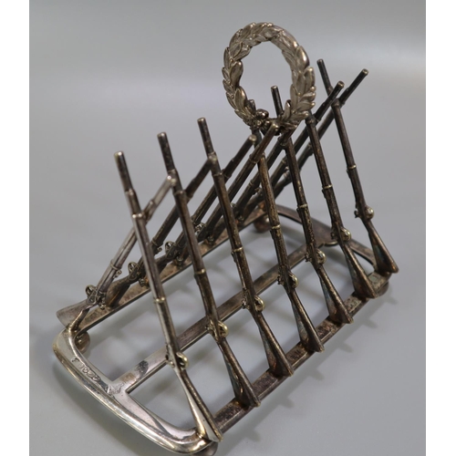 265 - Silver shooting trophy four division toast rack, the divisions in the form of Lee Enfield rifles, ha... 