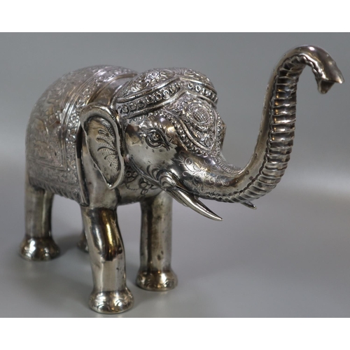 267 - Unusual, probably 19th century, Indian white metal caparisoned Indian elephant with headdress and fo... 