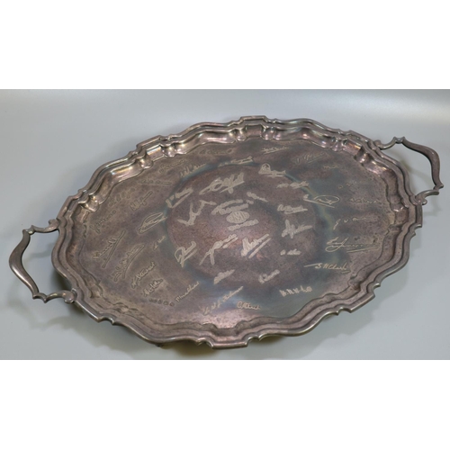 276 - Oval two handled silver piecrust edge presentation tray, overall with engraved signatures. Birmingha... 