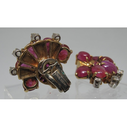 313 - A pair of fan shaped earrings set with star rubies, diamonds and cut rubies by Seaman Schepps.  Appr... 