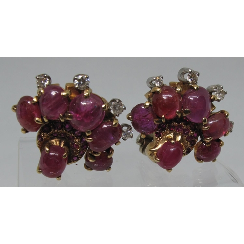 313 - A pair of fan shaped earrings set with star rubies, diamonds and cut rubies by Seaman Schepps.  Appr... 