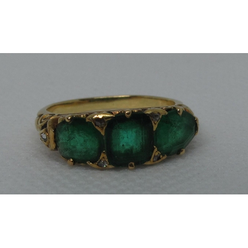 316 - A three stone emerald ring set in yellow metal.  Ring size M & 1/2.  Approx weight 4.8 grams.
(B.P. ...