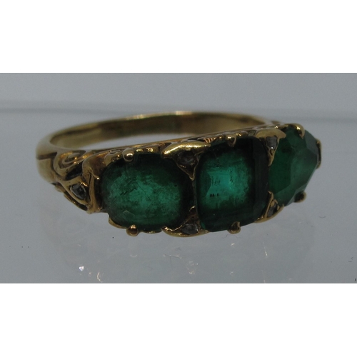 316 - A three stone emerald ring set in yellow metal.  Ring size M & 1/2.  Approx weight 4.8 grams.
(B.P. ... 