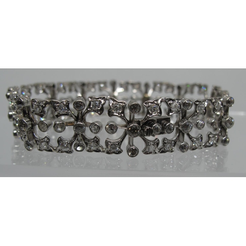 321 - Diamond openwork bracelet of hinged square links with hinged integral clasp.  Set in unmarked white ... 