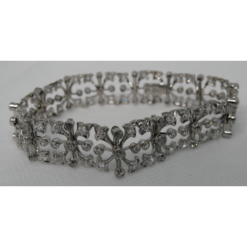 321 - Diamond openwork bracelet of hinged square links with hinged integral clasp.  Set in unmarked white ... 