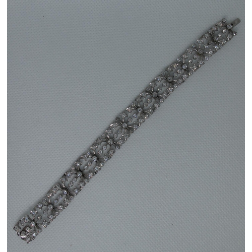 321 - Diamond openwork bracelet of hinged square links with hinged integral clasp.  Set in unmarked white ... 