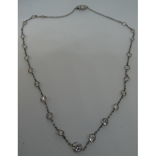 322 - A diamond necklace of twenty two graduated diamonds set in white metal with a diamond set clasp.  Le... 