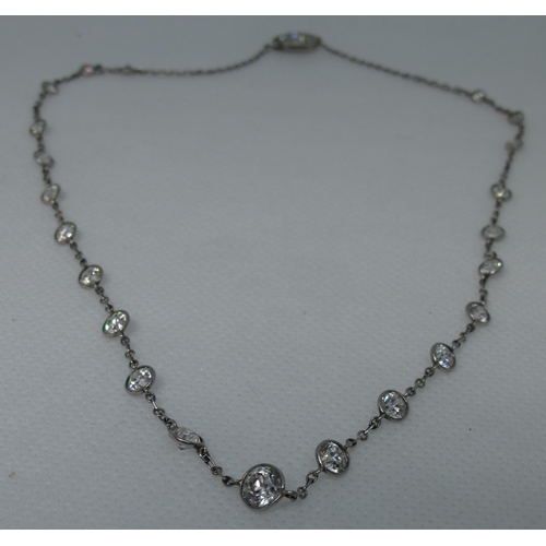 322 - A diamond necklace of twenty two graduated diamonds set in white metal with a diamond set clasp.  Le... 