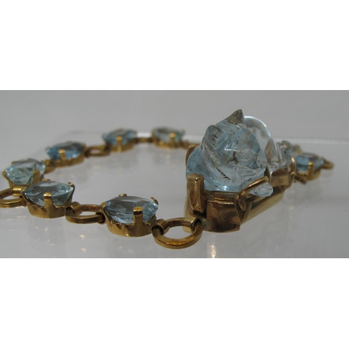 324 - An aquamarine bracelet of nine oval cut aquamarine stones, the clasp set with a large aquamarine car... 