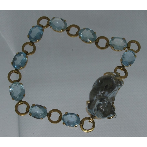 324 - An aquamarine bracelet of nine oval cut aquamarine stones, the clasp set with a large aquamarine car... 