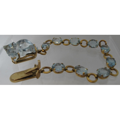 324 - An aquamarine bracelet of nine oval cut aquamarine stones, the clasp set with a large aquamarine car... 