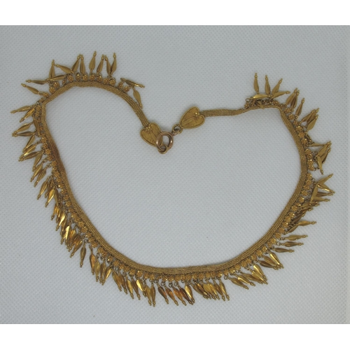 330 - A yellow metal fringe necklace.  Approx weight 42.6 grams.
(B.P. 21% + VAT)