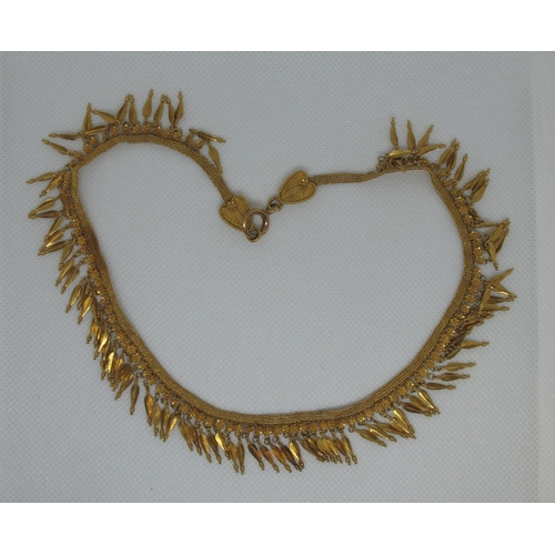 330 - A yellow metal fringe necklace.  Approx weight 42.6 grams.
(B.P. 21% + VAT)