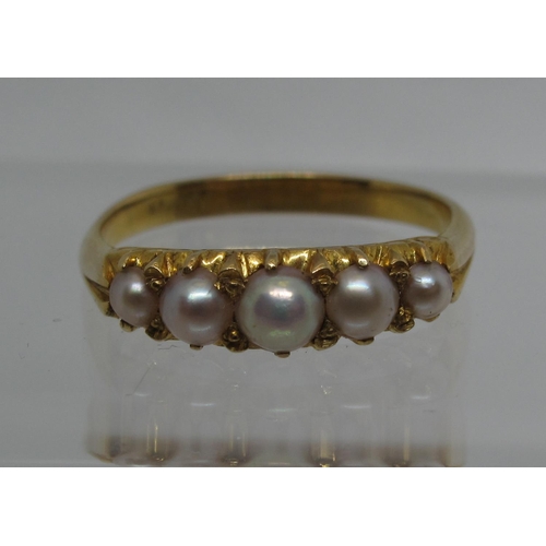 338 - A five stone pearl ring set in yellow metal.  Ring size P&1/2.  Approx weight 3.1 grams.
(B.P. 21% +... 