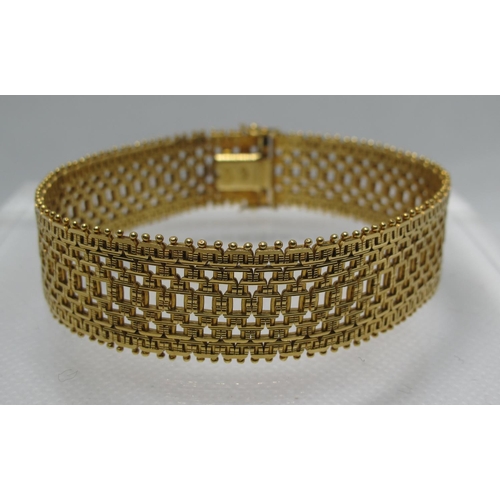 351 - 18ct gold wide bracelet with integral clasp and two safety clasps. Length 7.75 inches (18cm) Approx ... 