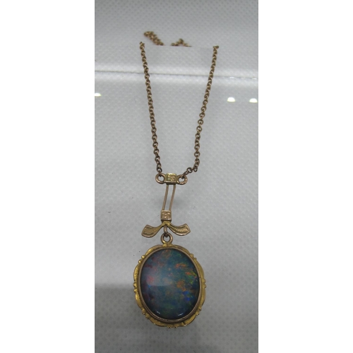 355 - An Edwardian opal pendant set in yellow metal on a yellow metal chain.  Approx weight 4.1 grams.
(B.... 